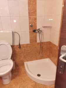 a bathroom with a toilet and a bath tub at Cozy Nook Cottage in Faneroméni +31 photos