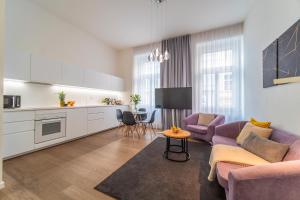 a living room with a couch and a table at A Prague Apartments - Lesser Town in Prague