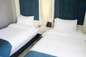 Postel nebo postele na pokoji v ubytování Rival Hotel Amman