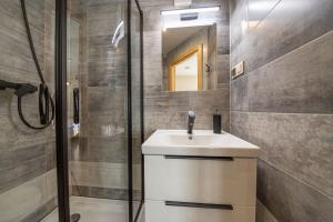 a bathroom with a sink and a shower at Apartamenty i pokoje gościnne Wajdówka in Zakopane
