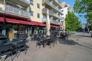 a group of tables and chairs in front of a building at Lovely central flat with great view in Oslo