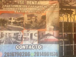 a sign in the window of a building at 1Dom Rep - Huge cozy 3 bedrooms - Electric transformer and Inverter- close to all transportation Jacobo Majluta - Residencial Paradise V Colina Arroyo 1 in Santo Domingo