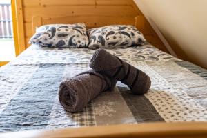 a stuffed animal is laying on a bed at Apartamenty i pokoje gościnne Wajdówka in Zakopane