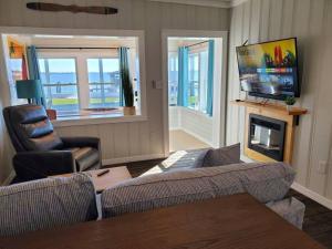 a living room with a couch and a television at Camp St. Cabanas Unit 3 on Lake Dora in Tavares