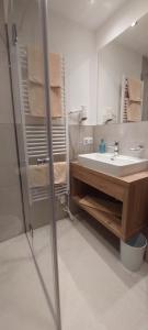 a bathroom with a white sink and a shower at Gästehaus Hochmuth in Mayrhofen +42 photos
