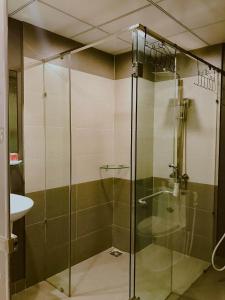 a glass shower in a bathroom with a sink at AnAn Homestay Huế in Hue +142 photos