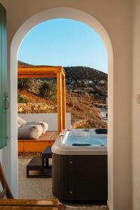 a hot tub in a room with a view of a mountain at Naxos Aethereal View in Kastraki Naxou