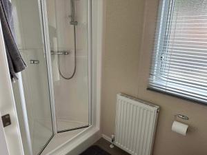 a bathroom with a shower and a toilet paper roll at The Hideaway in Alnwick +20 photos