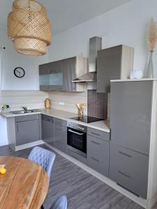 a kitchen with stainless steel appliances and a wooden table at Blick zum Brückentor in Traben-Trarbach