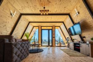 a living room with wooden ceilings and a vaulted ceiling at Paunova Koliba in Knić