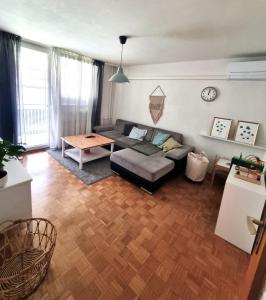 a living room with a couch and a table at Apartment Gulek in Zreče