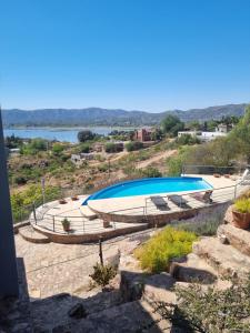 a large swimming pool on top of a hill at casa del lago -villa carlos paz in Villa Carlos Paz