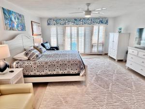 a bedroom with a bed and a ceiling fan at Victoria's View in Duck +118 photos