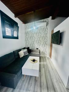 a living room with a couch and a table at APARTAMENTO EL CUCHI in Sanlúcar de Barrameda
