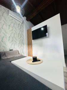 a room with a tv on a white wall at APARTAMENTO EL CUCHI in Sanlúcar de Barrameda +28 photos