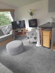 a living room with a couch and a table at Arnies Place in Longridge