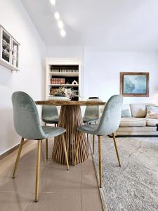 a dining room with a table and two chairs at Apartamento Vetalegua Jerez in Jerez de la Frontera