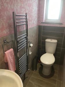 a bathroom with a white toilet and a sink at Large double room next to Elisabeth Line in Abbey Wood