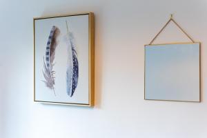two framed pictures of feathers hanging on a wall at Parking - Spacious - Smart TV - Self CheckIn - Garden - King in Derby