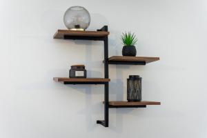 a shelf on a wall with three tiers at Parking - Spacious - Smart TV - Self CheckIn - Garden - King in Derby