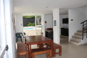 a living room with a table and a dining room with a pool at Villas del Guali - Piscina Privada in Santa Fe de Antioquia