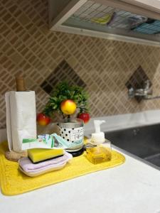 a kitchen counter with a yellow tray with paper towels at شقق وغرف خاصة in Hail