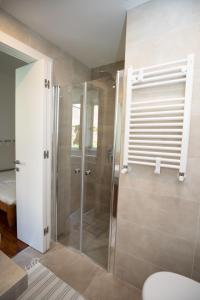 a shower with a glass door in a bathroom at Domus Cordara - Splendido appartamento nel verde in Rome