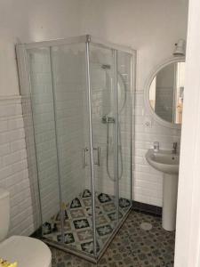 a bathroom with a glass shower and a sink at Casa Puerta sierra de Cádiz in Arcos de la Frontera