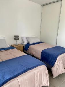 A bed or beds in a room at Departamento Cordillera II