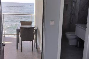 a bathroom with a table and a view of the ocean at 'A Bucha' by The Cliff Coast in Paul do Mar