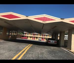 a gas station with a car parked in front of it at Budget Inn in Denison
