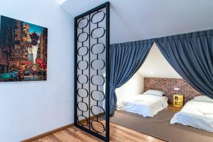 a bedroom with two beds and a mirror at bukit indah 265 in Johor Bahru