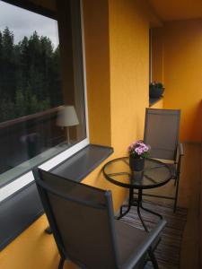 a room with a table and chairs and a window at Liepaja Pine Apartment in Liepāja