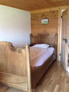 a bedroom with a wooden bed in a room at Ferienhaus Rütiweid in Appenzell