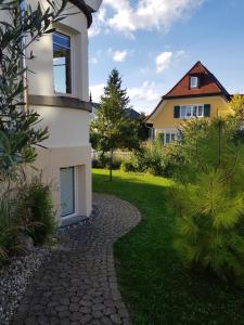 a house with a pathway leading to a yard at Fewo Simone - Überlingen City - in Überlingen
