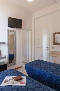 a hotel room with a bed and a mirror at Hotel Smart Cervia in Cervia