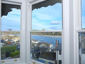 a window with a view of a harbor at Dartmouth Cottage - River and Sea Views with Parking Permit in Dartmouth