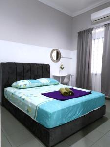 a bedroom with a bed with a stuffed animal on it at YK Homestay in Kulai