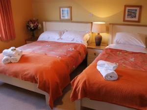 a bedroom with two beds with towels on them at Blossom Hill Bed and Breakfast in Killaloe