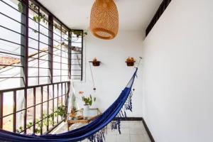 a blue hammock in a room with a window at Casa de Luz in Cali
