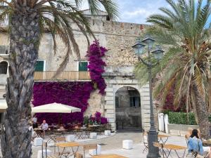 a building with purple flowers on the side of it at Appartamento Cavour in Ventimiglia