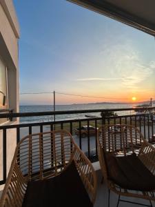 balcón con 2 sillas y vistas al océano en Sea View Loft, en Nea Roda