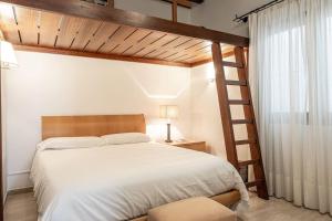 a bedroom with a large bed and a ladder at Las Rocas Beach-Ciutat Jardi Playa in Palma de Mallorca