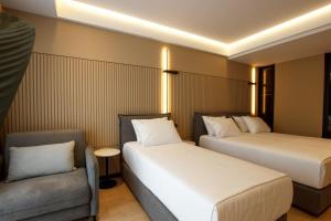 Postel nebo postele na pokoji v ubytování Caramel Boutique Hotel