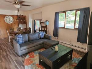 a living room with a couch and a table at Indian Lake House in Worcester