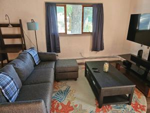 a living room with a couch and a coffee table at Indian Lake House in Worcester