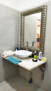 a bathroom with a sink and a mirror at Villa Majid in Rabat