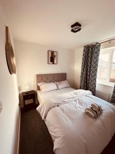 a bedroom with a white bed and a window at Newhaven House in Liverpool