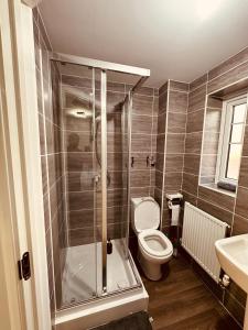 a bathroom with a shower and a toilet and a sink at Newhaven House in Liverpool