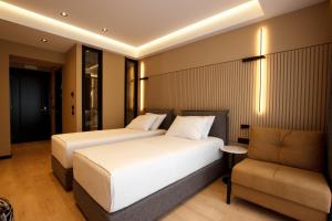 Postel nebo postele na pokoji v ubytování Caramel Boutique Hotel